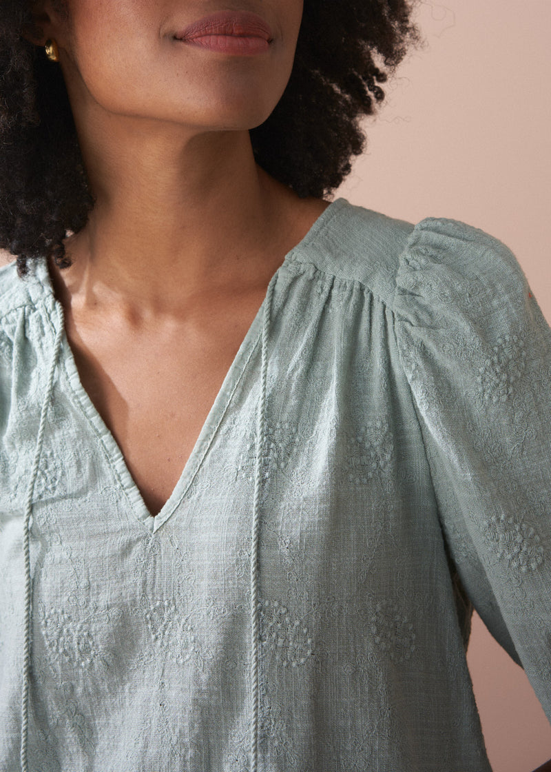 Sage green embroidered top with tassel detail