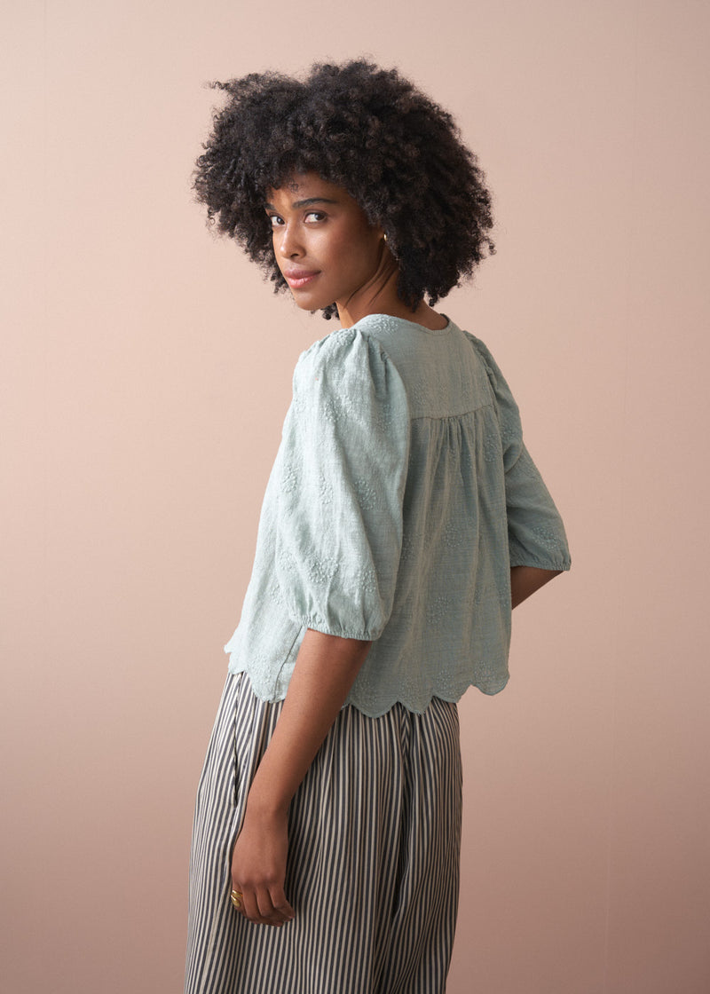 Sage green embroidered top with tassel detail