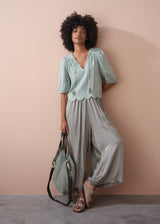 Sage green embroidered top with tassel detail