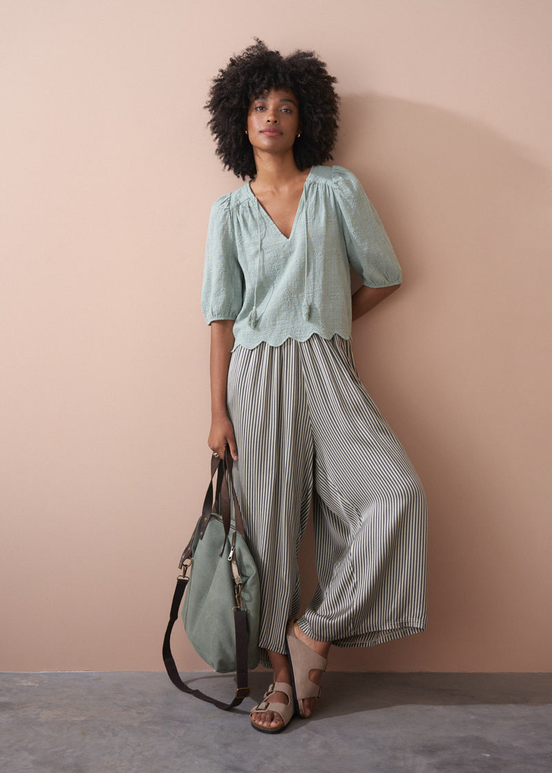 Sage green embroidered top with tassel detail