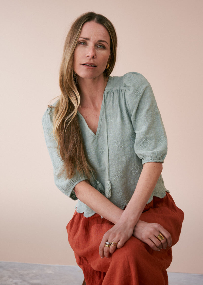 Sage green embroidered top with tassel detail