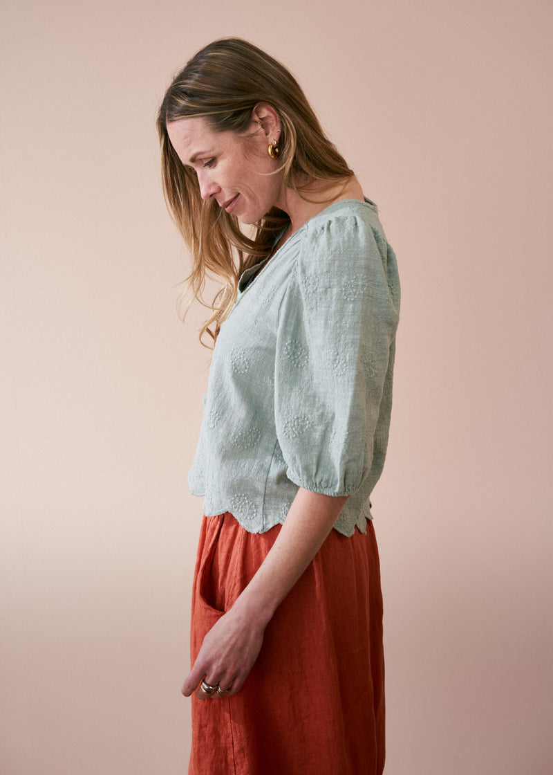 Sage green embroidered top with tassel detail