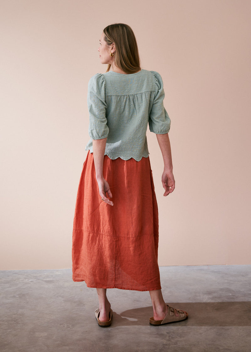 Sage green embroidered top with tassel detail