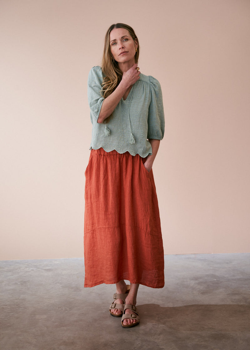 Sage green embroidered top with tassel detail