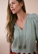 Sage green embroidered top with tassel detail