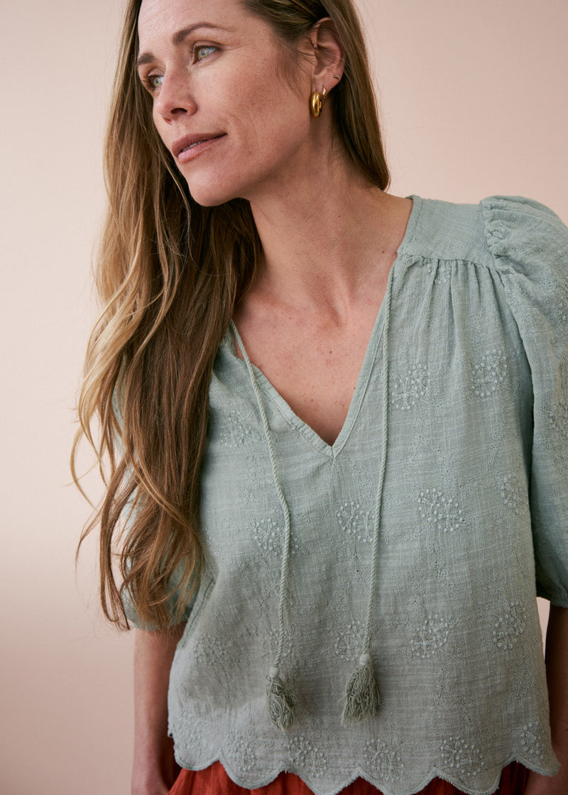 Sage green embroidered top with tassel detail