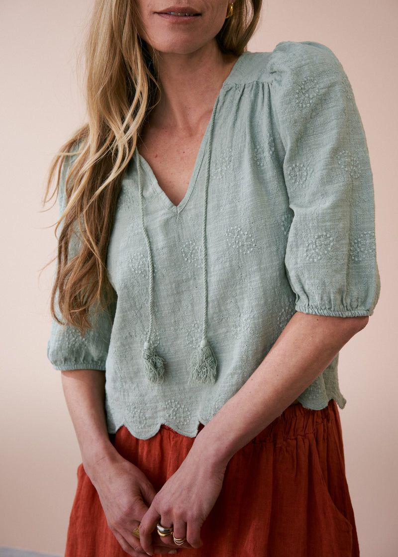 Sage green embroidered top with tassel detail