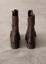Pair of brown leather boots on a textured gray surface