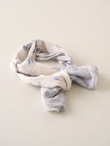 Folded fabric with blue patterns on a beige background