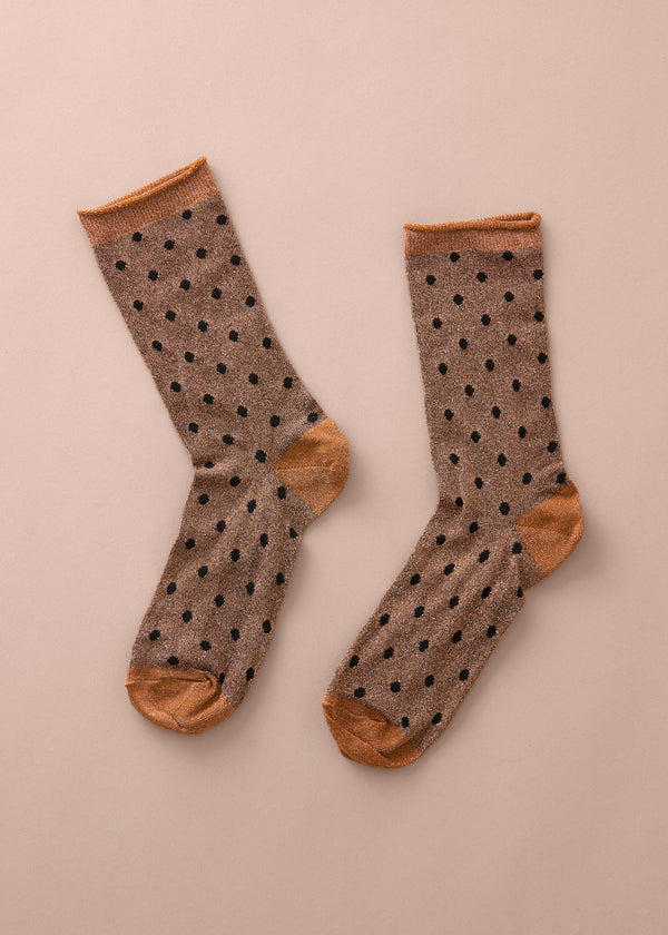 Pair of socks with polka dot pattern on a beige background