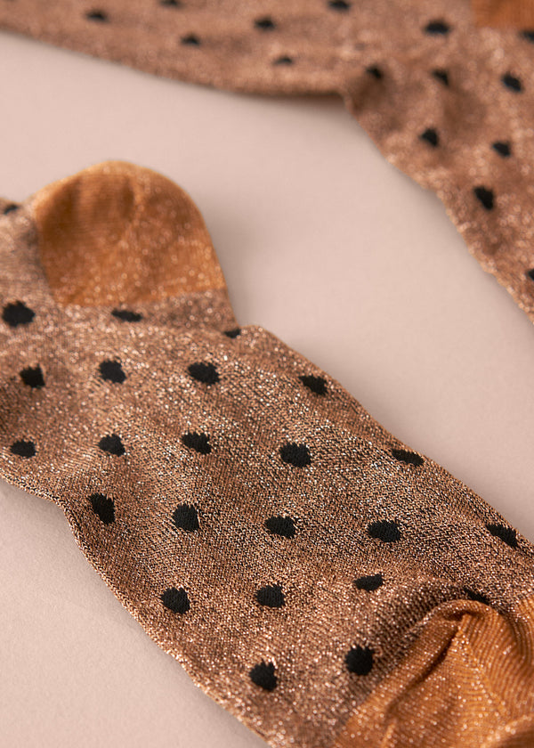 Brown socks with black polka dots on a light background
