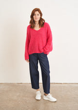 Bright pink knitted sweater with v neck line