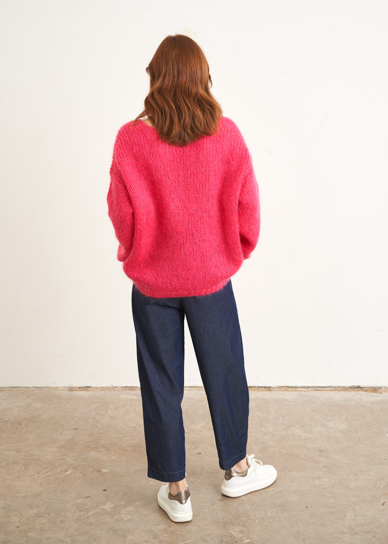 Bright pink knitted sweater with v neck line