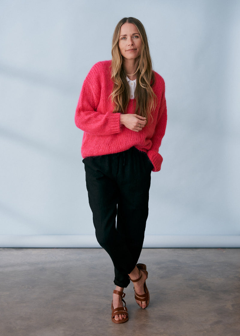 Bright pink knitted sweater with v neck line