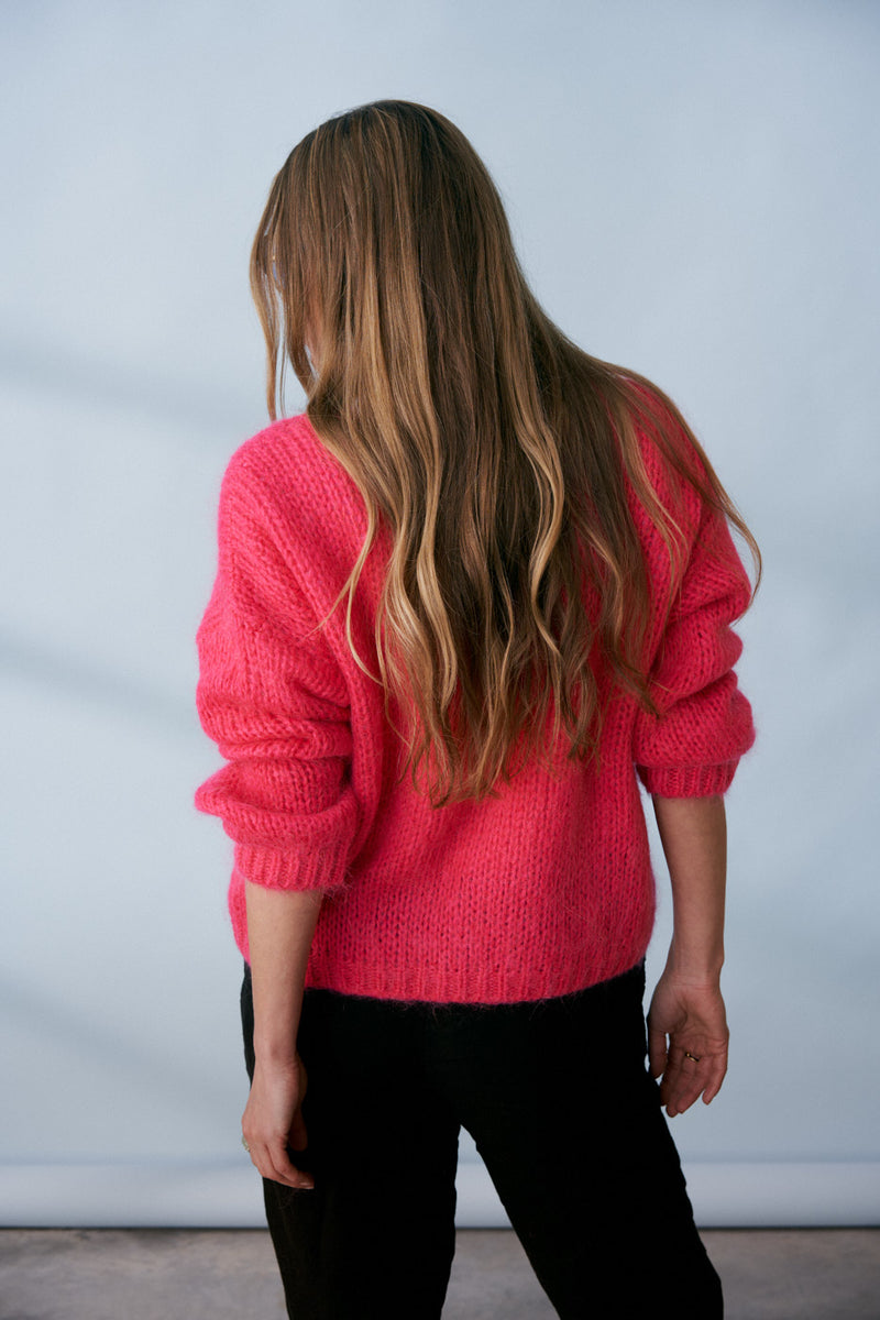 Bright pink knitted sweater with v neck line