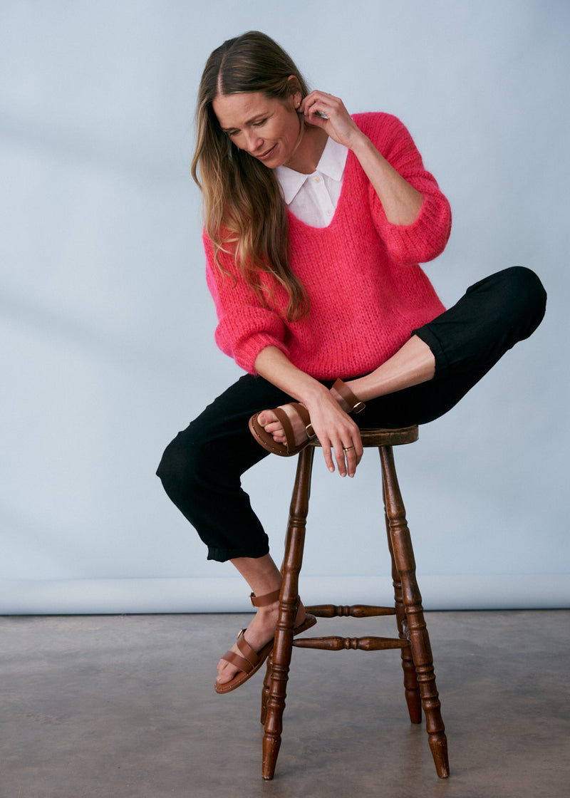Bright pink knitted sweater with v neck line