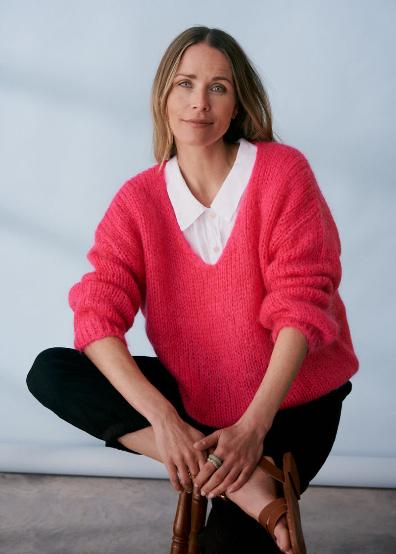 Bright pink knitted sweater with v neck line