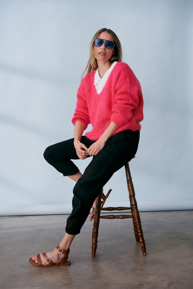 Bright pink knitted sweater with v neck line