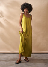 Woman wearing a yellow dress against a beige background
