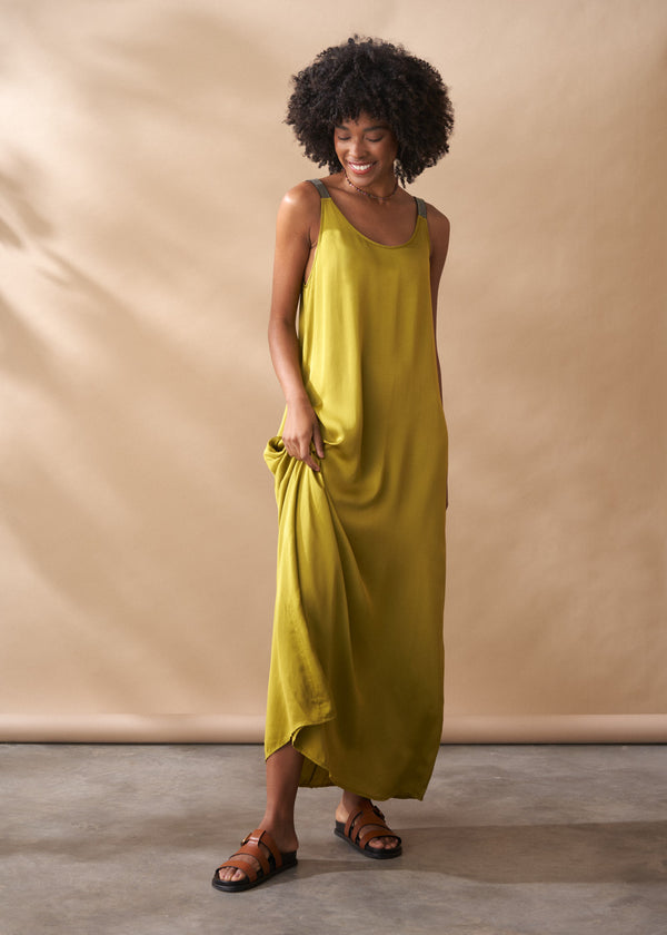 Woman wearing a yellow dress against a beige background