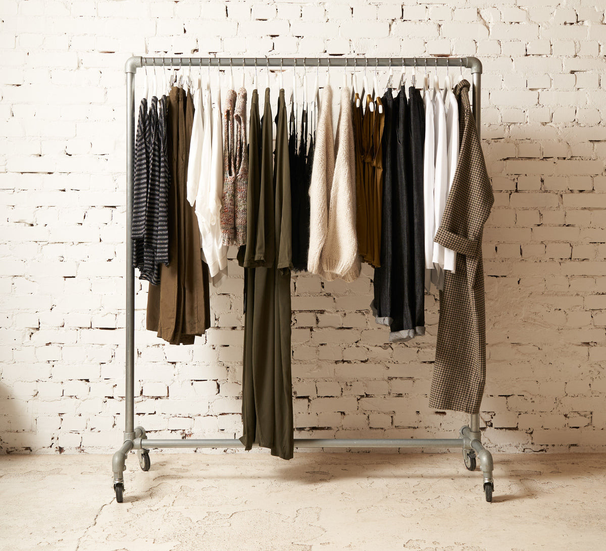 Neutral women's clothing displayed on a minimalist clothing rack