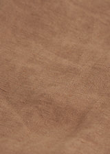 A close up of the texture of linen in a camel brown 