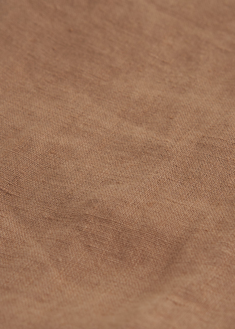 A close up of the texture of linen in a camel brown 