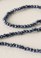 Close-up of a beaded necklace on a beige background