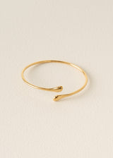 Gold bracelet on a beige background