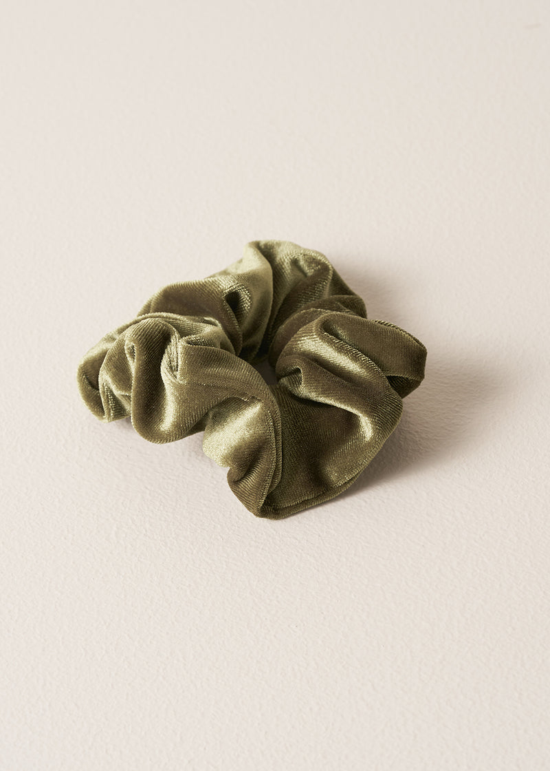 Green scrunchie on a beige background
