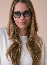 Oversized circular sunglasses with tortoiseshell pattern and blue lenses