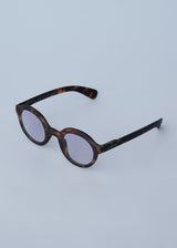 Oversized circular sunglasses with tortoiseshell pattern and blue lenses