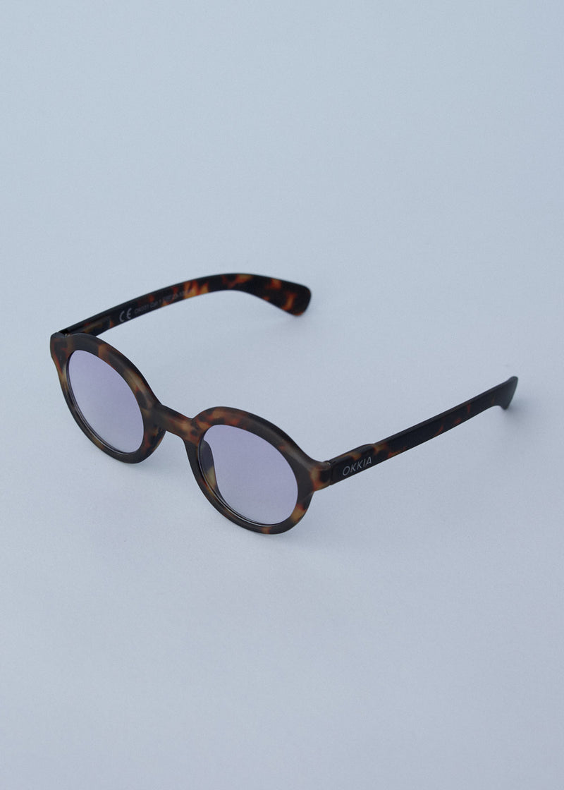 Oversized circular sunglasses with tortoiseshell pattern and blue lenses