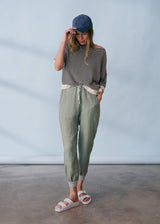 Sage green linen trousers with metallic trim