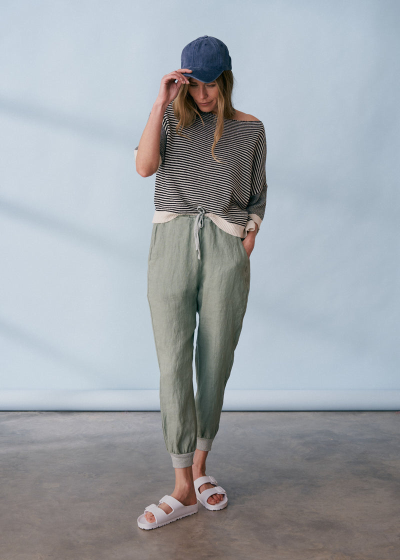 Sage green linen trousers with metallic trim