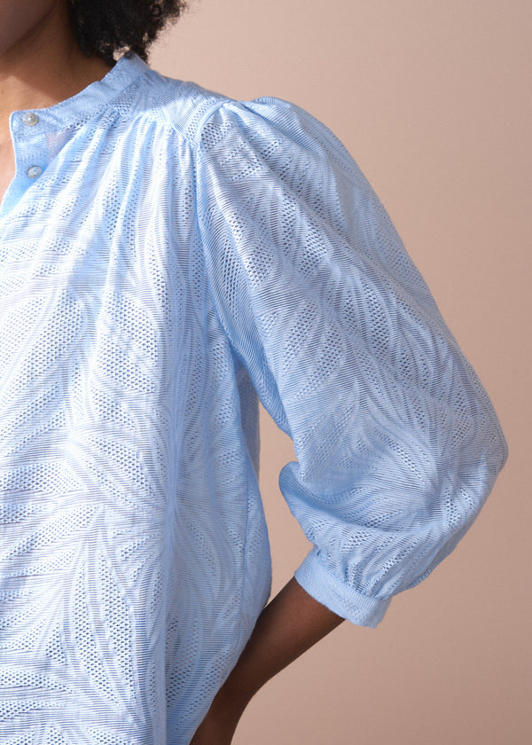 Light blue textured lacey blouse with puff sleeves