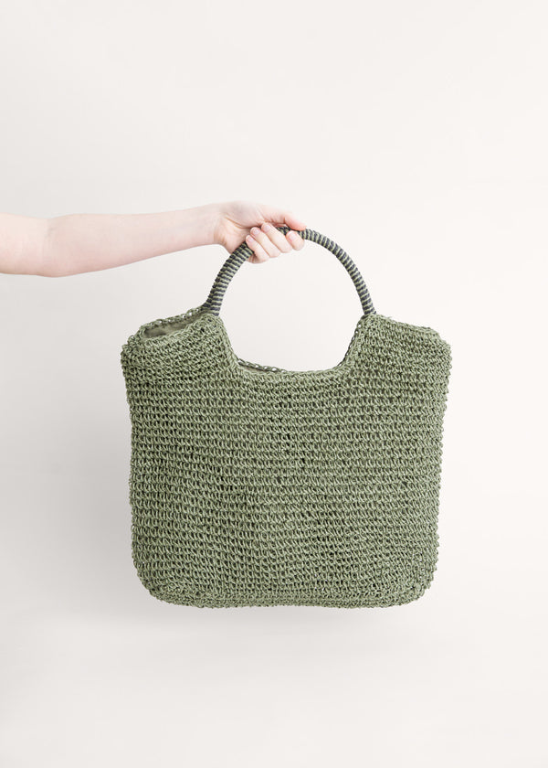 A green tote shopper bag made from crochet raffia