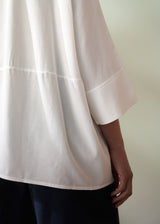 White blouse with a plain background