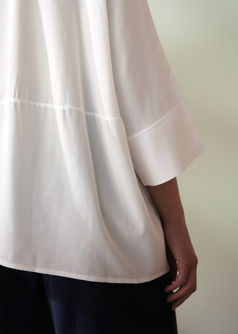 White blouse with a plain background