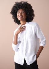Woman wearing a white shirt against a beige background