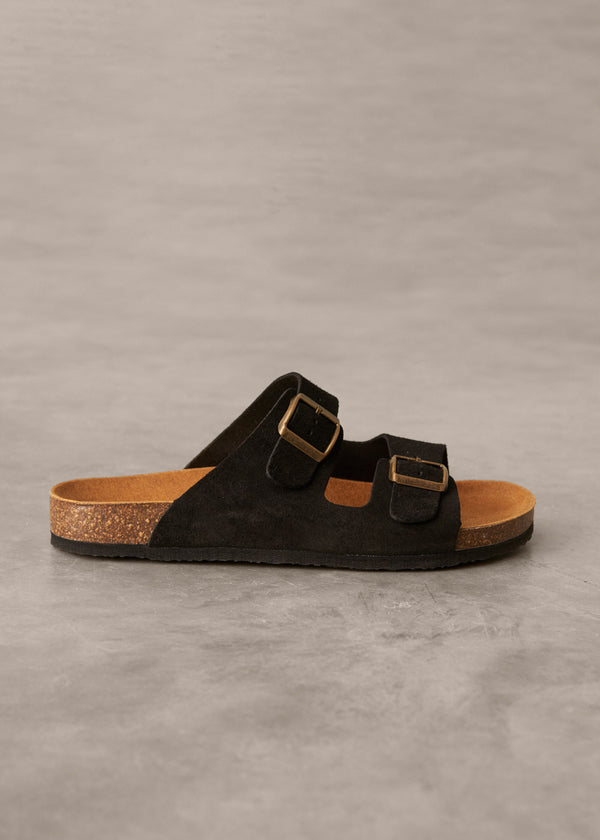 Black sandal with cork sole on a gray background