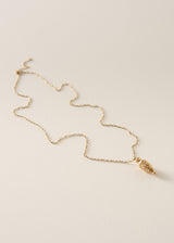 A delicate gold chain necklace with a textured, organic-shaped gold pendant, displayed on a clean, light beige textured background.