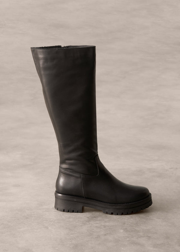 Black knee-high boot on a gray background