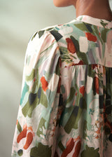 Close-up of a person wearing a floral dress with a blurred background