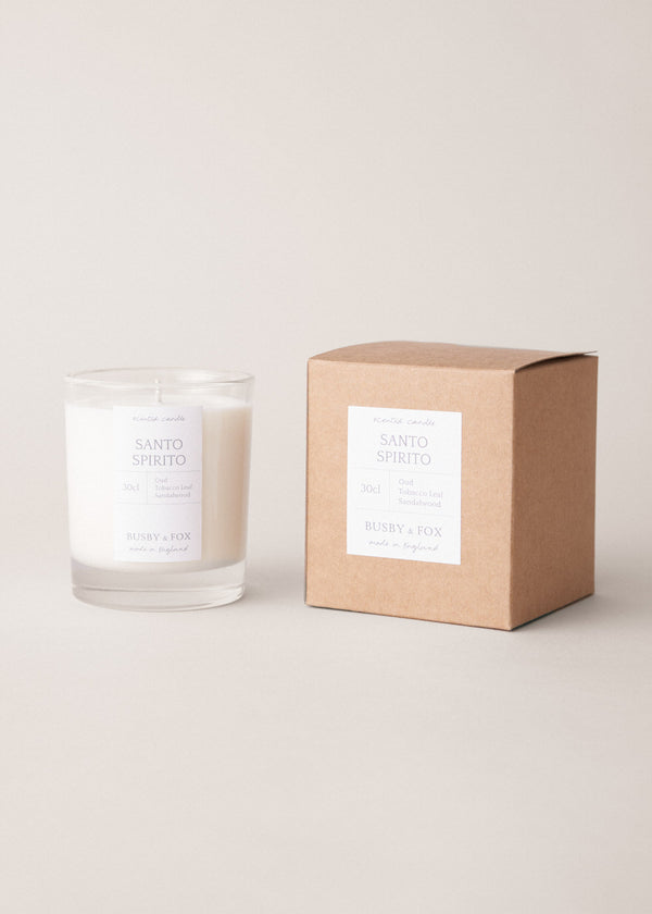 Candle and its packaging on a light background