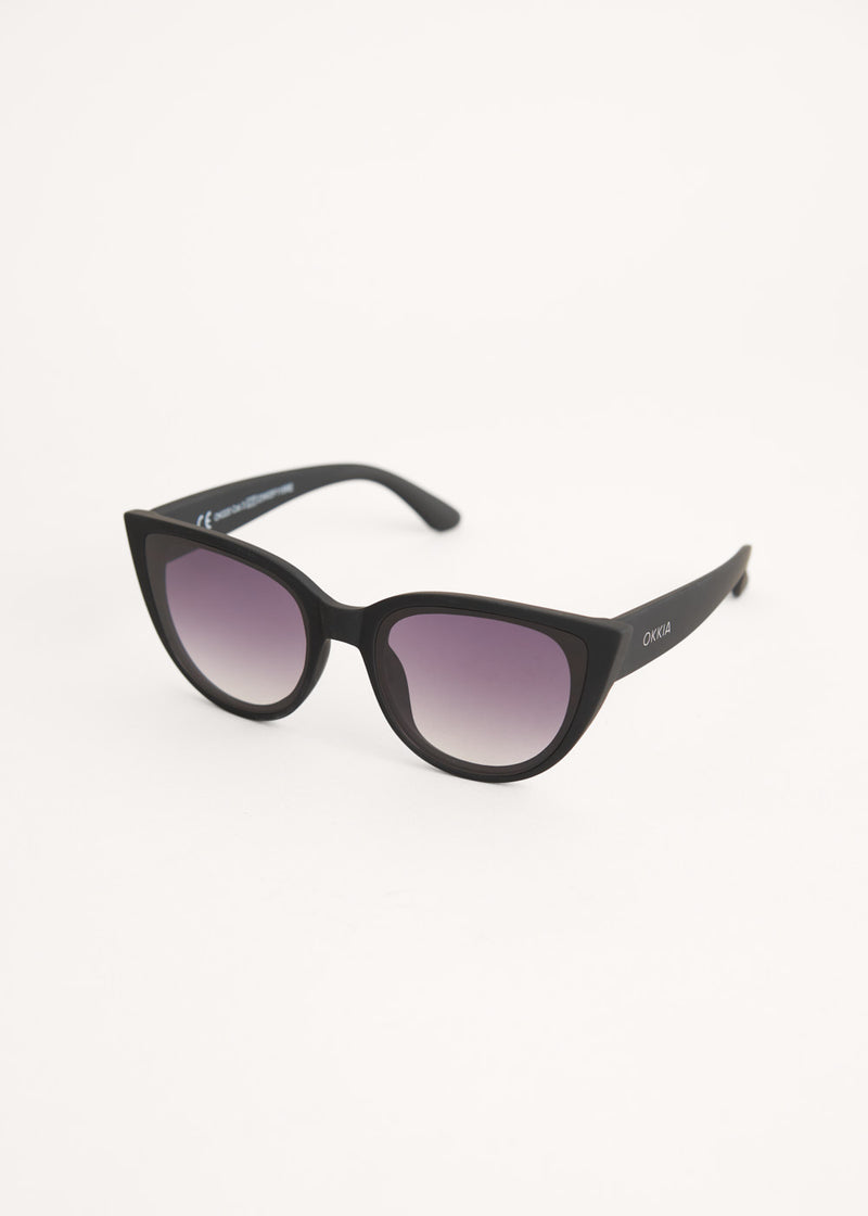 A pair of oversized cat eye sunglasses with black frames and blue lenses