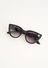 A pair of oversized cat eye sunglasses with black frames and blue lenses