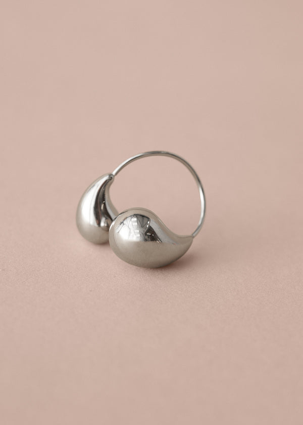 Silver twist ring on a beige background