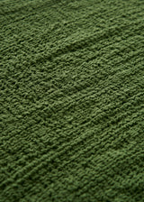 An olive green crinkled gauze scarf