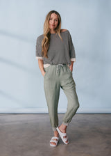 Sage green linen trousers with metallic trim